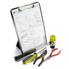Foldable easel clipboard in standing form, with papers in clip section and tools laying in front of picture